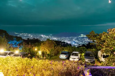 a group of cars parked in a parking lot at night at Las Cabañitas, el boqueron in San Salvador