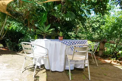 a table with chairs and a blue and white table cloth at Las Cabañitas, el boqueron in San Salvador