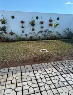 a brick wall with potted plants on it at Elegante casa a minutos de Centro comercial in San Miguel
