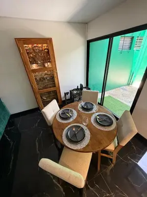 a dining room with a wooden table and chairs at Casa Miralvalle in San Salvador