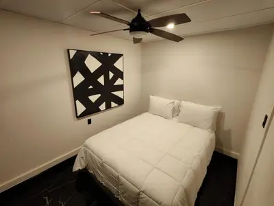 a bedroom with a bed with a ceiling fan at Casa Miralvalle in San Salvador