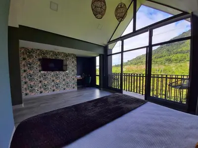a bedroom with a bed and a large window at Hotel Nido de Pájaro in Los Naranjos