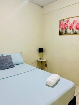 a bedroom with a bed and a painting on the wall at Casa Virginia, AC, Close to Downtown, Private in Santa Ana