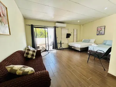 a living room with two beds and a couch at Casa Virginia, AC, Close to Downtown, Private in Santa Ana