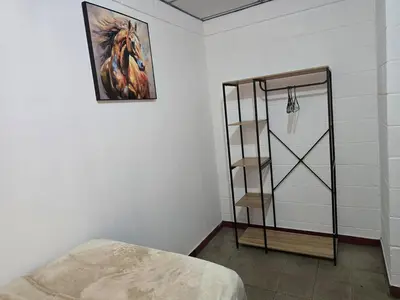 a room with a bed and a painting on the wall at New House in Ciudad Merliot in Hacienda Plan de La Laguna