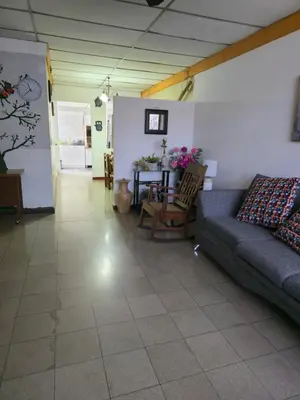 a living room with a couch and a table at New House in Ciudad Merliot in Hacienda Plan de La Laguna