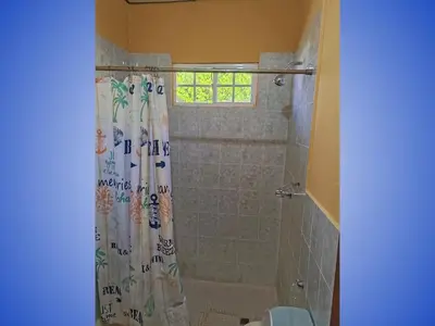 a bathroom with a shower with a shower curtain at Sueño del Pacifico in La Libertad