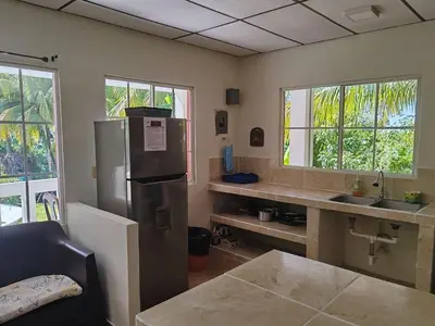 a kitchen with a stainless steel refrigerator and a counter at Sueño del Pacifico in La Libertad