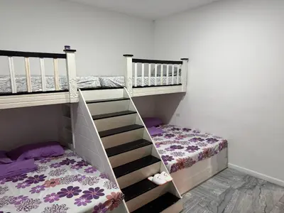 two bunk beds in a room with a bed at Rancho El Valle in Acajutla