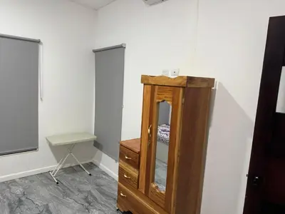 a room with a wooden dresser and a mirror at Rancho El Valle in Acajutla