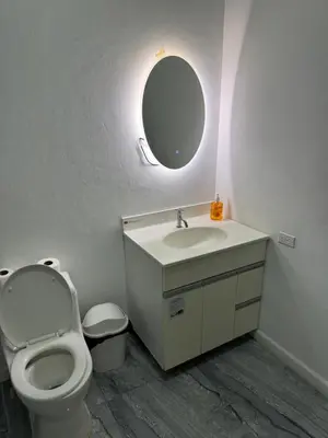 a bathroom with a toilet and a sink and a mirror at Rancho El Valle in Acajutla