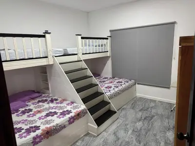 two bunk beds in a room with a staircase at Rancho El Valle in Acajutla
