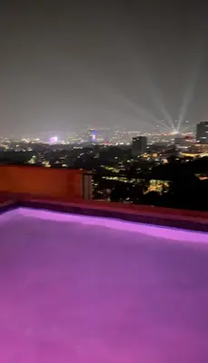 a room with a view of a city at night at Apartment With Pool In Colonia Escalon in San Salvador
