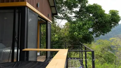 a house with a balcony with a view at Dreamy cabin in Comasagua, La Libertad in Comasagua