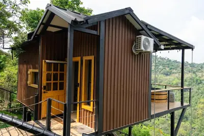 a small building with yellow doors on a deck at Dreamy cabin in Comasagua, La Libertad in Comasagua
