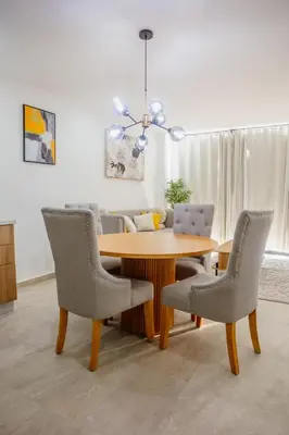 a dining room with a table with chairs and a couch at Apartment In The Greatest San Salvador in San Salvador