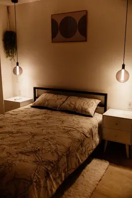 a bedroom with a bed with two night stands and two lamps at Apartment In The Greatest San Salvador in San Salvador