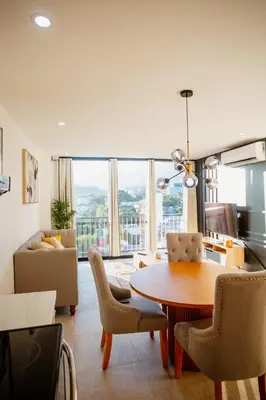 a kitchen and living room with a table and chairs at Apartment In The Greatest San Salvador in San Salvador