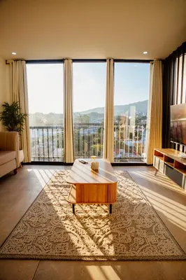 a living room with a coffee table and large windows at Apartment In The Greatest San Salvador in San Salvador