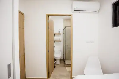 a bathroom with a toilet and a sink in a room at Apartment In The Greatest San Salvador in San Salvador