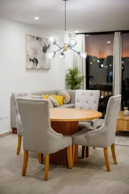 a dining room table with chairs and a couch at Apartment In The Greatest San Salvador in San Salvador