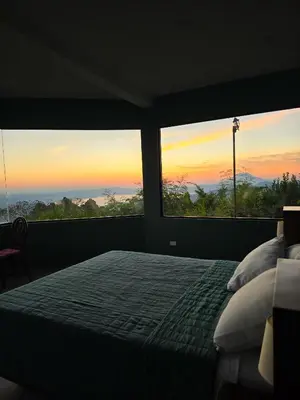a bedroom with a bed with a sunset view at Monticello in San Marcos