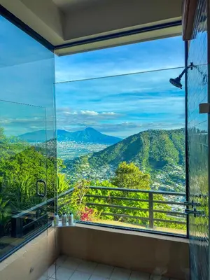 a room with a large window looking out at the mountains at Monticello in San Marcos