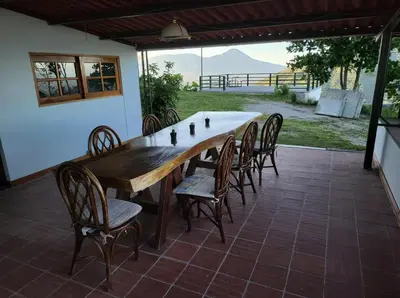 a large wooden table and chairs on a patio at Monticello in San Marcos