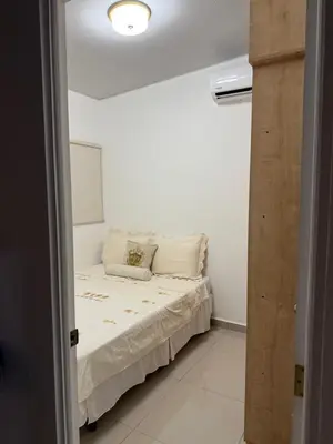 a bedroom with a bed in a white room at Golden House in San Miguel