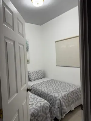 a small room with two beds and a door at Golden House in San Miguel