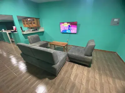a living room with a couch and two chairs at Casa Apaneca in Apaneca