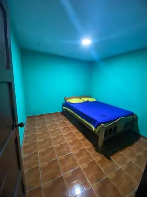 a room with a bed in a blue room at Casa Apaneca in Apaneca