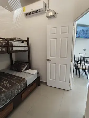 a bedroom with two bunk beds and a door at Luxury Living Apartment P1001 in San Miguel