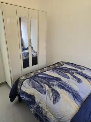 a bedroom with a bed and two mirrors at Luxury Living Apartment P1001 in San Miguel