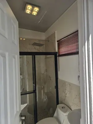a bathroom with a shower and a toilet and a sink at Luxury Living Apartment P1001 in San Miguel