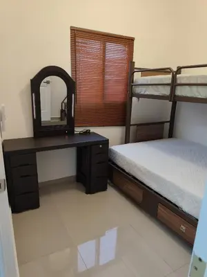 a bedroom with two bunk beds and a vanity with a mirror at Luxury Living Apartment P1001 in San Miguel