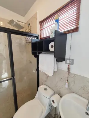 a bathroom with a toilet and a sink and a shower at Luxury Living Apartment P1001 in San Miguel