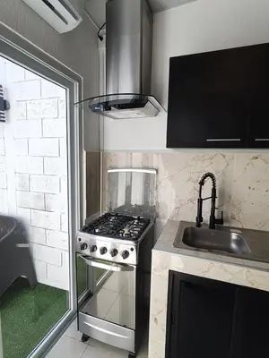 a small kitchen with a stove and a sink at Luxury Living Apartment P1001 in San Miguel