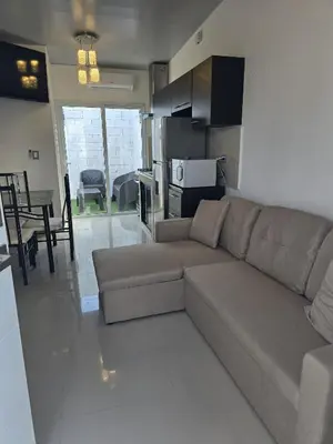 a living room with a couch and a kitchen at Luxury Living Apartment P1001 in San Miguel