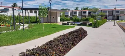 a sidewalk in front of a park with benches and buildings at Peach Haven 143 in San Juan Opico