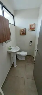 a bathroom with a toilet and a sink at Peach Haven 143 in San Juan Opico