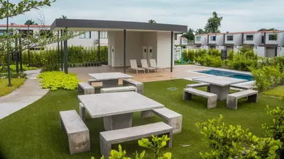 a patio with picnic tables and a swimming pool at Peach Haven 143 in San Juan Opico