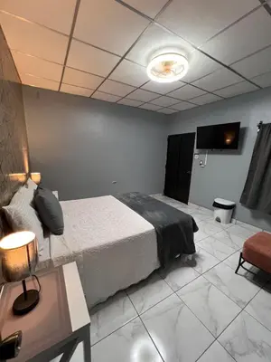 a bedroom with a bed and a table and a couch at Casa Victoria in San Miguel