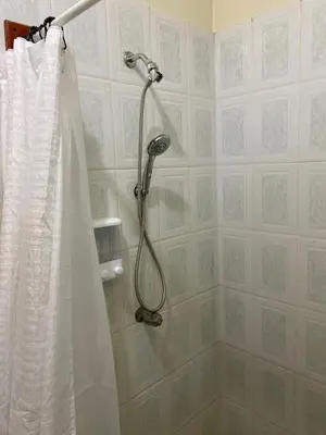 a shower with a shower curtain in a bathroom at Casa Victoria in San Miguel