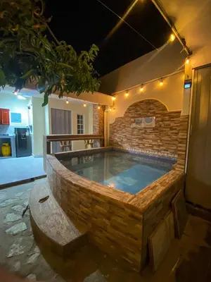 a large plunge pool in a brick building with a bench at Casa Victoria in San Miguel
