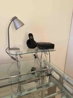 a glass table with a phone and a lamp on it at Beatiful Condo in Escalon near WTC building and Masferrer in San Salvador