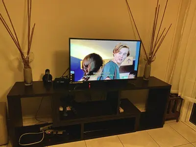 a flat screen tv sitting on a stand at Beatiful Condo in Escalon near WTC building and Masferrer in San Salvador