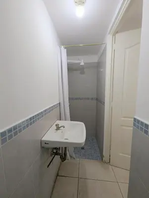 a white bathroom with a sink and a shower at Habitaciones Privadas en Memories Flowershop - Colonia Escalón, Plaza Futura in San Salvador