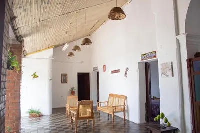a room with chairs and tables in a building at Hostal Los Milagros in Santa Ana