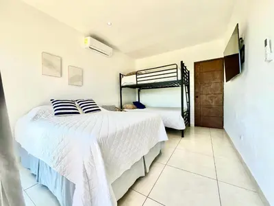 a bedroom with two beds and a bunk bed at Casa de lujo- Vista- Piscina- La Libertad in La Libertad
